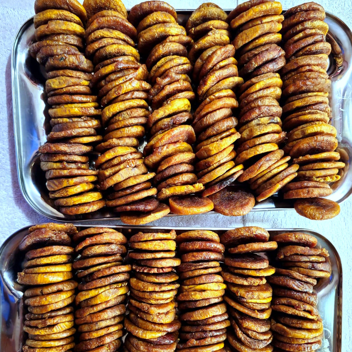 Sun dried figs on steel trays after drying